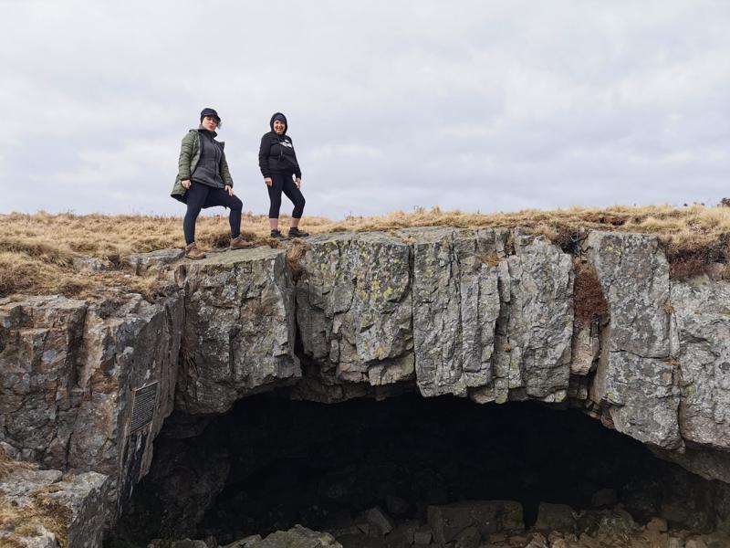 Walkers above a cave
